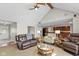 Open concept living room with vaulted ceiling, a ceiling fan, and views of kitchen and entry at 101 Edgewater Dr, Noblesville, IN 46062