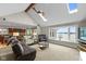 Bright living room with large windows and a vaulted ceiling with ceiling fan and skylights at 101 Edgewater Dr, Noblesville, IN 46062