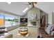 Living room features a fireplace, large windows with water views, and a vaulted ceiling with skylights at 101 Edgewater Dr, Noblesville, IN 46062