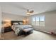 Cozy bedroom with a comfortable bed, ceiling fan, and a large window offering a scenic view of the lake at 101 Edgewater Dr, Noblesville, IN 46062