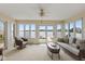 Bright sunroom boasts scenic lake views with comfortable seating and multiple windows at 101 Edgewater Dr, Noblesville, IN 46062