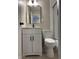 A bathroom featuring a modern sink, toilet, and a framed shower with a sliding glass door at 10328 Central Ave, Carmel, IN 46280