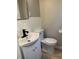A bathroom featuring a new white vanity with a black faucet and a standard toilet at 10328 Central Ave, Carmel, IN 46280