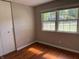Bedroom with hardwood flooring, built-in closet, and natural light from the window at 10328 Central Ave, Carmel, IN 46280