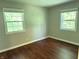 Bedroom featuring hardwood floors, neutral paint, and two windows at 10328 Central Ave, Carmel, IN 46280