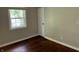 Bedroom featuring hardwood floors, neutral paint, one window, and a closet at 10328 Central Ave, Carmel, IN 46280