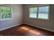 Cozy bedroom featuring hardwood floors and sun-filled double windows at 10328 Central Ave, Carmel, IN 46280