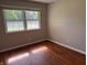 Bright bedroom featuring hardwood floors, and double hung windows at 10328 Central Ave, Carmel, IN 46280