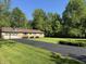 Brick ranch home on a lush lawn, featuring a basketball hoop at 10328 Central Ave, Carmel, IN 46280