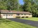 Brick home featuring an attached garage, well maintained landscaping, and basketball hoop at 10328 Central Ave, Carmel, IN 46280