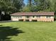 Charming brick home with attached garage and well-manicured lawn at 10328 Central Ave, Carmel, IN 46280