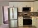 Modern kitchen with stainless steel appliances, white cabinets, and stylish fixtures at 10328 Central Ave, Carmel, IN 46280
