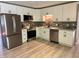 Bright kitchen featuring stainless steel appliances, white cabinets, and stylish backsplash at 10328 Central Ave, Carmel, IN 46280