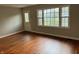 Bright living room featuring hardwood floors and a front door with leaded glass at 10328 Central Ave, Carmel, IN 46280