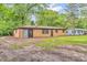 Rear view of a single-story brick house surrounded by a grassy area and mature trees at 10346 Wilson Rd, Brownsburg, IN 46112