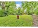 Expansive backyard with mature trees, blending natural beauty with a serene outdoor setting at 10346 Wilson Rd, Brownsburg, IN 46112