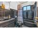 Cozy bathroom featuring black tiles, a vanity, and a shower with a patterned curtain at 10346 Wilson Rd, Brownsburg, IN 46112