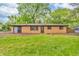 Brick home featuring a well-maintained lawn and mature trees, providing a serene and private setting at 10346 Wilson Rd, Brownsburg, IN 46112