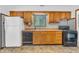 Standard kitchen featuring wood cabinets, appliances, and tiled backsplash at 10346 Wilson Rd, Brownsburg, IN 46112