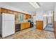Classic kitchen features wood cabinetry and standard appliances with tile flooring at 10346 Wilson Rd, Brownsburg, IN 46112