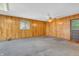 A carpeted living room is enhanced by natural wood paneling and an inviting, cozy atmosphere at 10346 Wilson Rd, Brownsburg, IN 46112