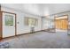 A neutral, carpeted living room features a large mirror for added visual space at 10346 Wilson Rd, Brownsburg, IN 46112