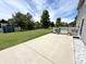Expansive backyard featuring a concrete patio, deck, shed, and lush green lawn, perfect for outdoor living and entertaining at 10847 Woodlook Ln, Indianapolis, IN 46239