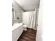Bathroom featuring a single vanity, hard surface floors, and a shower and tub combo with a white shower curtain at 10847 Woodlook Ln, Indianapolis, IN 46239