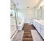 Bathroom featuring double vanity, hard surface floors, soaking tub, and a separate glass enclosed shower at 10847 Woodlook Ln, Indianapolis, IN 46239
