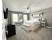 Bedroom with neutral carpet, decor, and two windows allowing ample natural light to enter the room at 10847 Woodlook Ln, Indianapolis, IN 46239