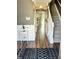 Inviting entryway with stylish wainscoting, hardwood floors, and an open view to the kitchen and stairway at 10847 Woodlook Ln, Indianapolis, IN 46239