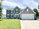 Charming two-story home featuring a two-car garage, a well-manicured lawn, and a welcoming front entrance at 10847 Woodlook Ln, Indianapolis, IN 46239