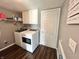 Functional laundry room with white washer and dryer, overhead cabinets, and ample storage space at 10847 Woodlook Ln, Indianapolis, IN 46239