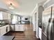 Open-concept kitchen and living room featuring hardwood floors, stainless steel appliances and a modern design at 10847 Woodlook Ln, Indianapolis, IN 46239