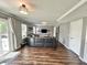 Spacious living room featuring hardwood floors, plenty of natural light, and sliding glass doors to the outdoor patio at 10847 Woodlook Ln, Indianapolis, IN 46239