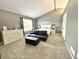 Spacious main bedroom with vaulted ceilings, a queen bed, sitting area, and ample natural light at 10847 Woodlook Ln, Indianapolis, IN 46239