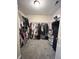 Walk-in closet with wire shelving and rods to efficiently store clothing and other personal items at 10847 Woodlook Ln, Indianapolis, IN 46239