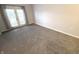 Bright bedroom with gray carpet, white trim, and french doors to a private balcony at 12860 University Cres # 1B, Carmel, IN 46032