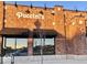 Brick commercial building with large windows, awnings and a modern exterior lighting design at 12860 University Cres # 1B, Carmel, IN 46032