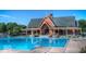 Large community pool with ample seating, a clubhouse and plenty of space to lounge poolside at 12860 University Cres # 1B, Carmel, IN 46032