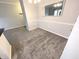 Neutral dining room featuring gray carpet, updated lighting, and white wainscoting at 12860 University Cres # 1B, Carmel, IN 46032
