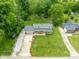 Aerial view showcases a well-maintained lawn, long driveway and basketball hoop leading to a welcoming two-story home at 12920 N Oakhaven Dr, Camby, IN 46113
