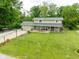 Expansive front lawn with a long driveway leading to a two-story home featuring a welcoming front porch at 12920 N Oakhaven Dr, Camby, IN 46113