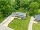 Aerial view shows a house with a spacious front yard and long driveway, nestled amongst mature trees in a friendly neighborhood at 12920 N Oakhaven Dr, Camby, IN 46113