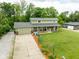 Aerial view showcasing a beautiful, well-maintained yard, long driveway and welcoming two-story home at 12920 N Oakhaven Dr, Camby, IN 46113