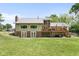 The back of a two-story house boasts a deck, patio, and spacious yard, ideal for outdoor relaxation and activities at 12920 N Oakhaven Dr, Camby, IN 46113