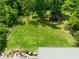 Aerial shot displays backyard with deck and lush surrounding greenery at 12920 N Oakhaven Dr, Camby, IN 46113