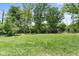 Lush backyard featuring a storage shed and mature trees, with plenty of space for recreation and relaxation at 12920 N Oakhaven Dr, Camby, IN 46113