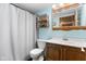 Bathroom features blue walls, dark tile floor, a shower/tub with curtain and wooden accents at 12920 N Oakhaven Dr, Camby, IN 46113