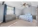 Bedroom features a ceiling fan, carpeting, and a large window, with natural light at 12920 N Oakhaven Dr, Camby, IN 46113